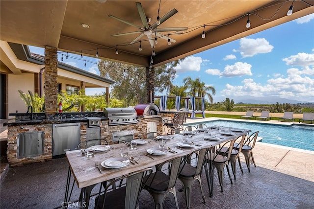 view of patio with ceiling fan, area for grilling, a grill, and sink