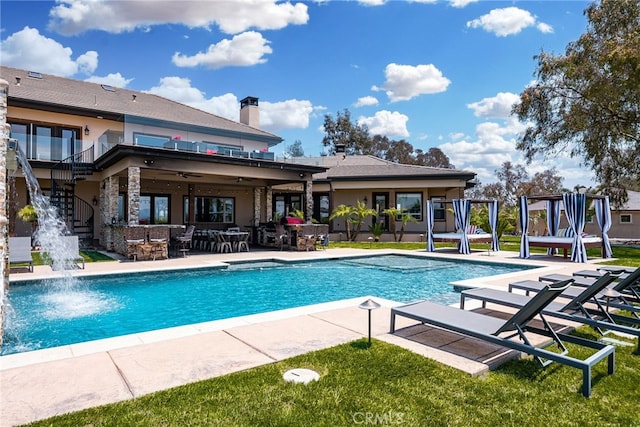 view of pool featuring pool water feature and a patio area