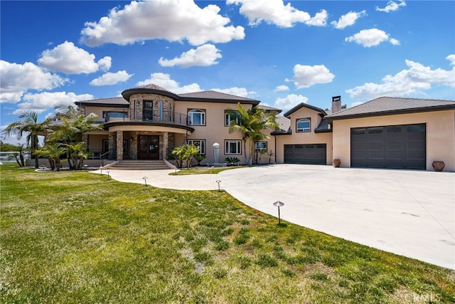 view of front of house featuring a garage, a balcony, and a front lawn