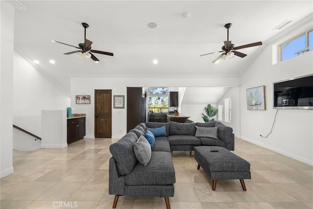 living room with lofted ceiling, ceiling fan, light tile patterned floors, and ornamental molding