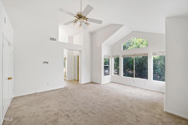 unfurnished living room featuring high vaulted ceiling, a ceiling fan, visible vents, and light colored carpet