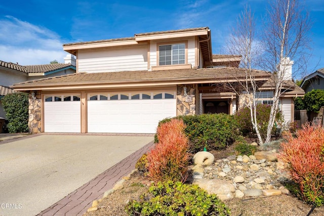 view of front facade featuring stone siding and concrete driveway