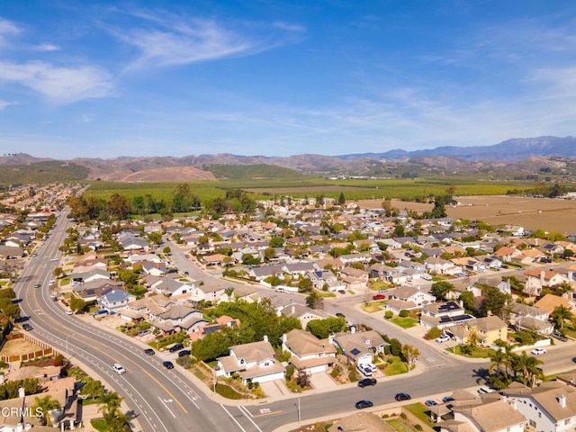 drone / aerial view featuring a residential view and a mountain view