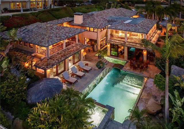 view of swimming pool with a patio and a pool with connected hot tub