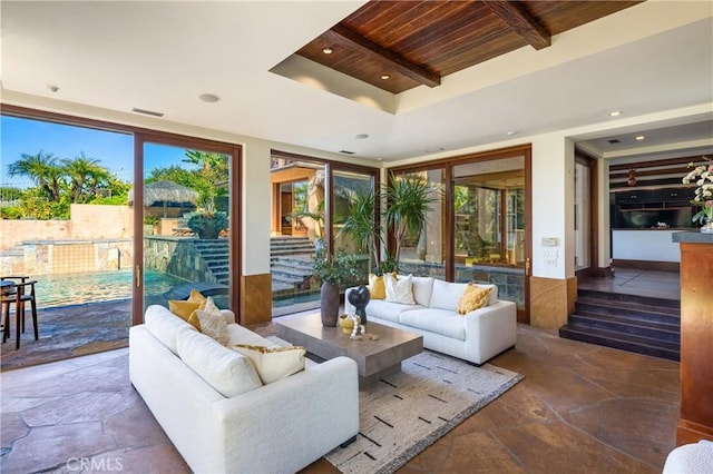 living area with stone tile flooring, wood ceiling, beamed ceiling, and recessed lighting