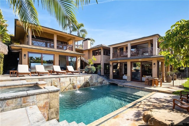 view of swimming pool featuring a patio area, an in ground hot tub, and pool water feature