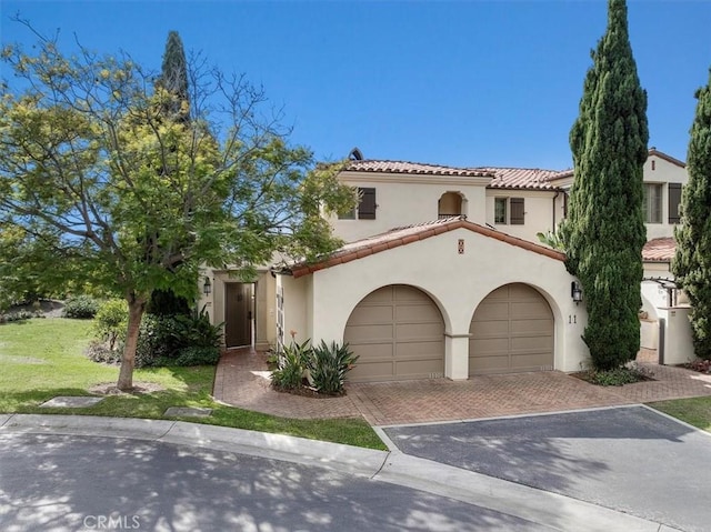 mediterranean / spanish home with a front lawn