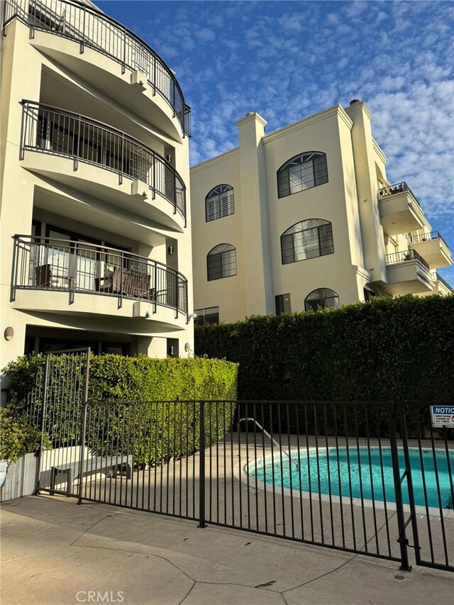 view of swimming pool featuring fence and a fenced in pool