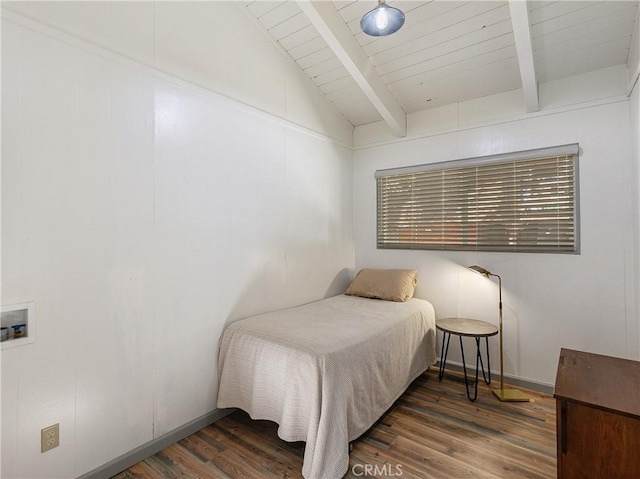 bedroom with dark wood-style flooring, baseboards, and vaulted ceiling with beams