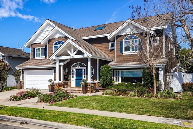 craftsman-style home featuring a garage and a front lawn