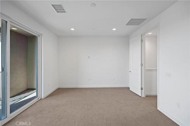 unfurnished room featuring light carpet