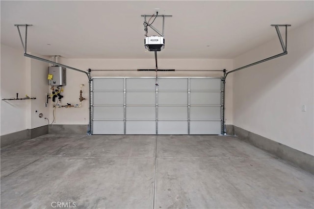 garage featuring water heater and a garage door opener