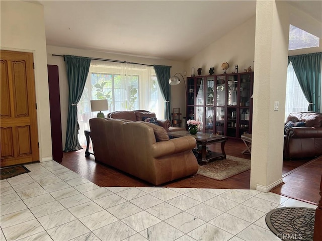 living room with light tile patterned flooring and lofted ceiling