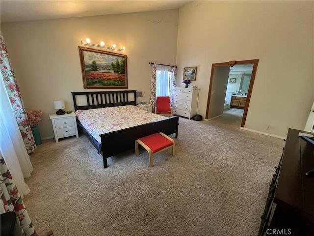 bedroom with carpet, high vaulted ceiling, and connected bathroom