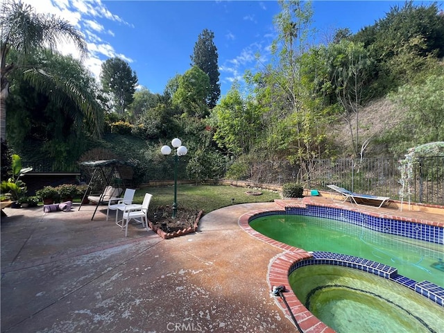 view of pool featuring an in ground hot tub and a patio area