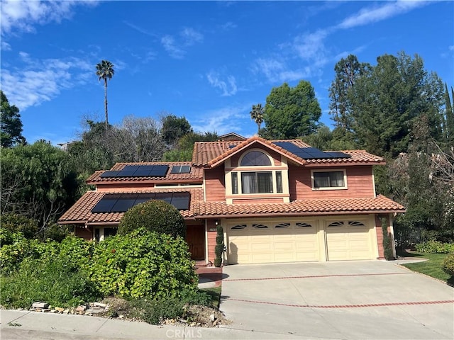 mediterranean / spanish-style house with a garage