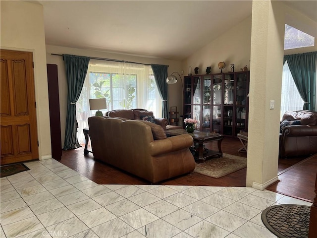 tiled living room with lofted ceiling