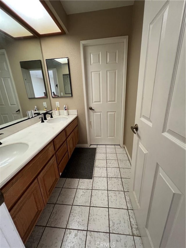 bathroom with tile patterned flooring and vanity