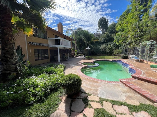 view of swimming pool with a patio and an in ground hot tub