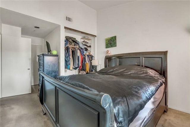 bedroom featuring a closet, visible vents, and light carpet