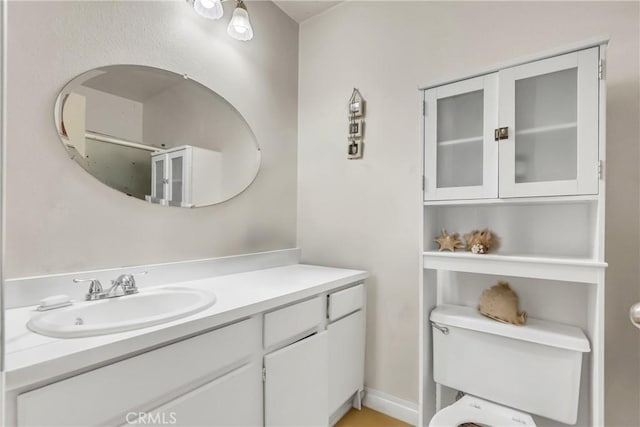 bathroom featuring toilet and vanity