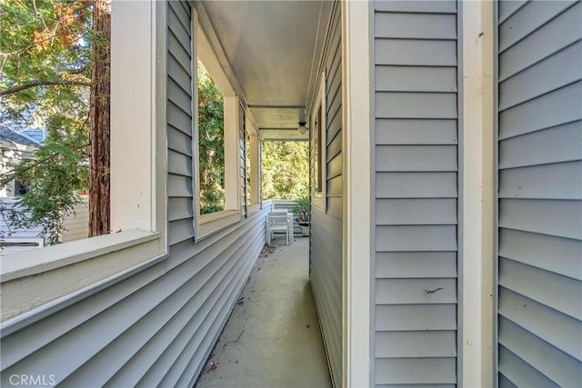 view of side of property featuring covered porch