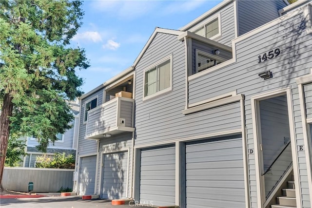 exterior space featuring a garage and a balcony
