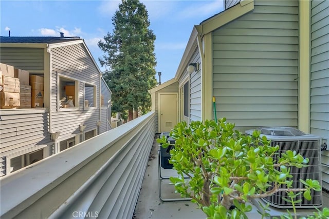view of property exterior with a balcony and cooling unit