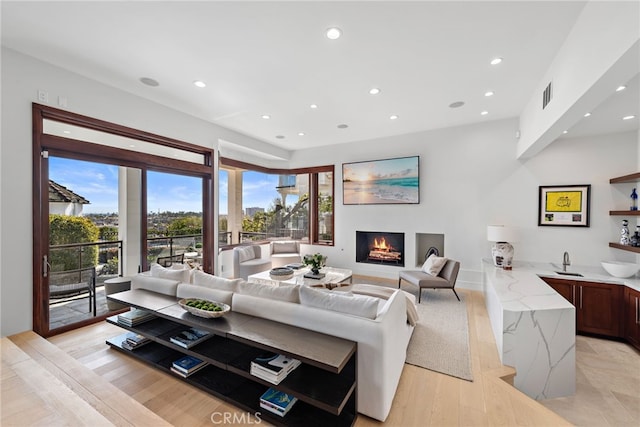 living room featuring indoor wet bar and light wood-type flooring