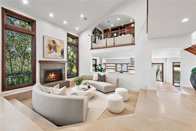 tiled living room featuring a high ceiling