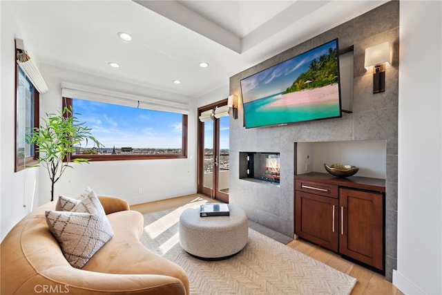 living area with a fireplace and light hardwood / wood-style floors