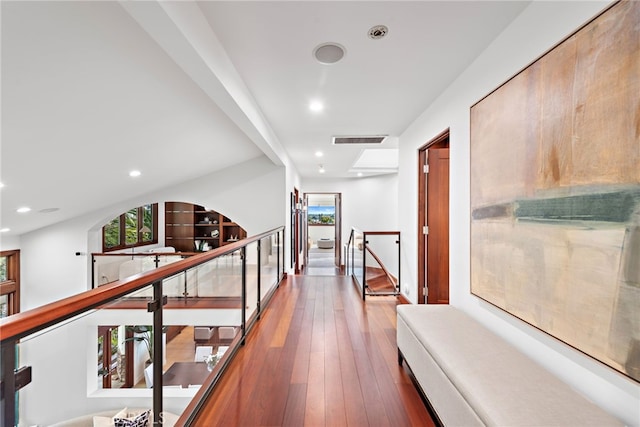 corridor with hardwood / wood-style flooring