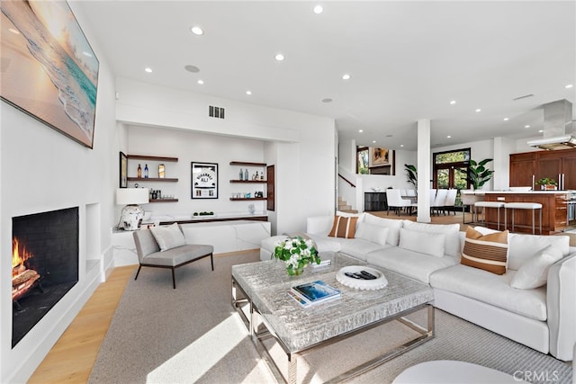 2907 Cliff Dr, Newport Beach, CA 92663 - living room featuring recessed lighting, light wood-style flooring, and a lit fireplace