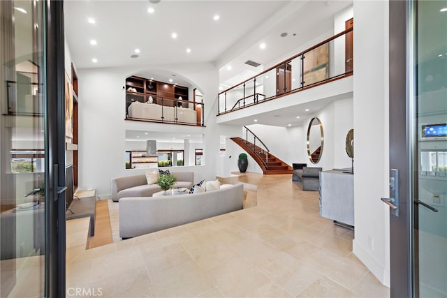 2907 Cliff Dr, Newport Beach, CA 92663 - living area with a high ceiling, recessed lighting, light tile patterned floors, stairs, and baseboards