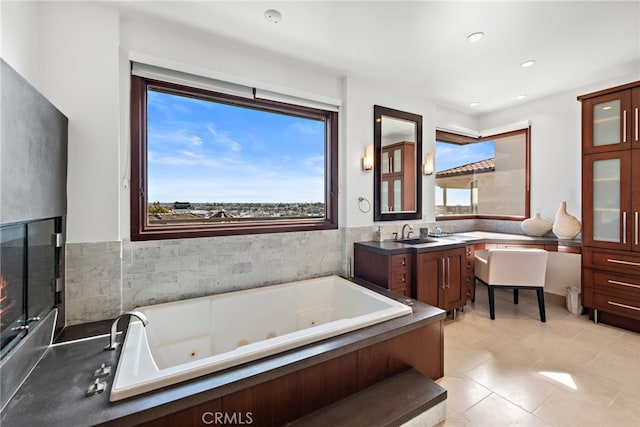 2907 Cliff Dr, Newport Beach, CA 92663 - bathroom featuring a jetted tub, healthy amount of natural light, recessed lighting, and wainscoting