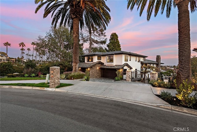 2907 Cliff Dr, Newport Beach, CA 92663 - view of front of property featuring stucco siding, a garage, concrete driveway, and stone siding