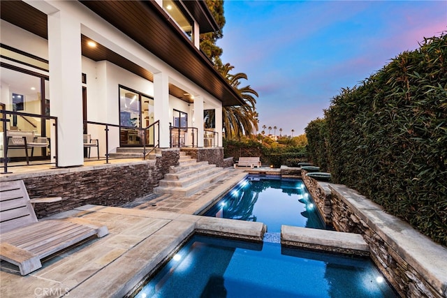 2907 Cliff Dr, Newport Beach, CA 92663 - pool at dusk with a pool with connected hot tub