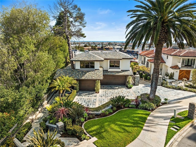 view of front facade with a front yard and a garage