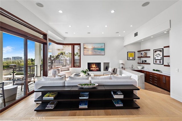 2907 Cliff Dr, Newport Beach, CA 92663 - living room featuring recessed lighting, a lit fireplace, and light wood-style flooring