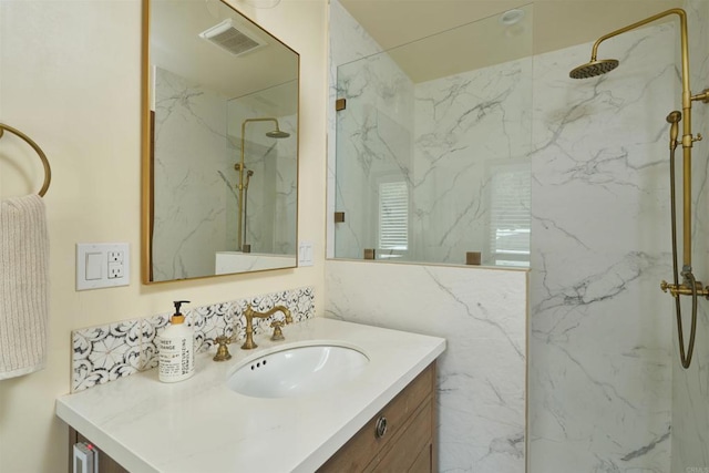 bathroom featuring vanity and tiled shower