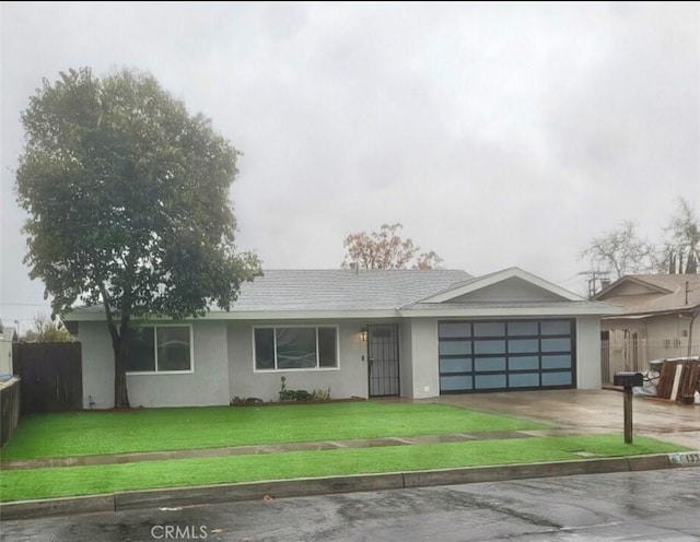 ranch-style home with a front yard and a garage