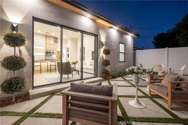 view of patio featuring fence and an outdoor living space