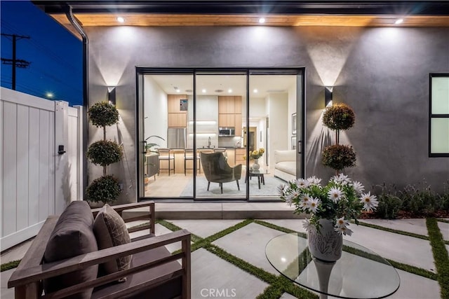 view of patio with a sink and fence