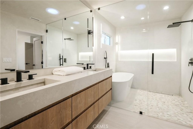 full bathroom with recessed lighting, visible vents, a soaking tub, a shower stall, and double vanity