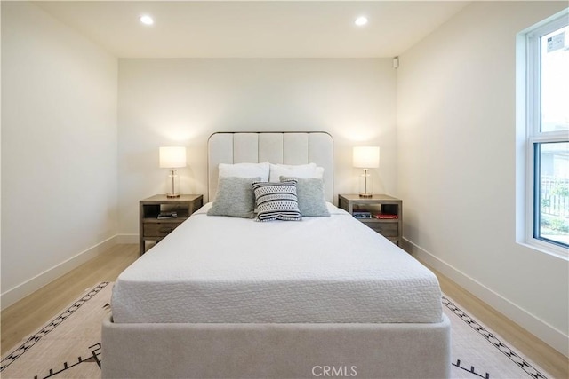 bedroom featuring recessed lighting, light wood-style flooring, and baseboards