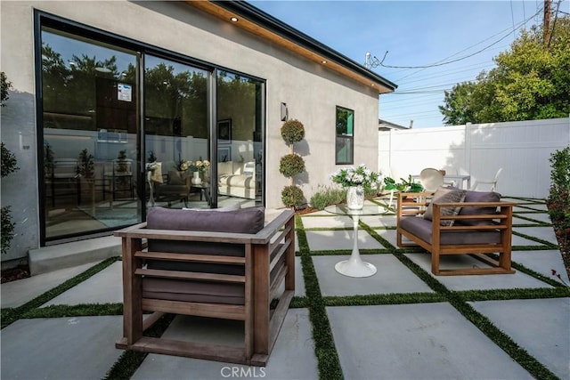 view of patio / terrace featuring fence and an outdoor hangout area