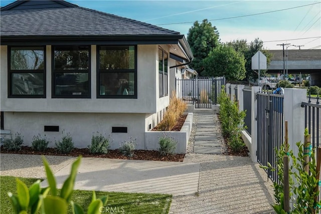 18848 Collins St, Tarzana, CA 91356 - view of home's exterior featuring stucco siding, fence, and a shingled roof