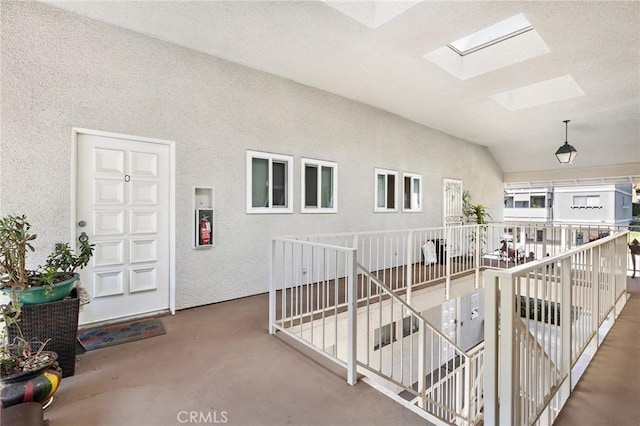 hallway with a skylight and an upstairs landing