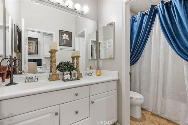 bathroom featuring toilet, vanity, and tile patterned flooring