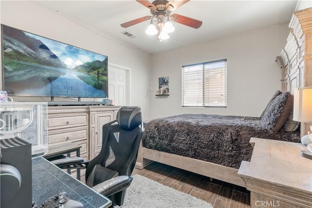 bedroom with hardwood / wood-style floors and ceiling fan